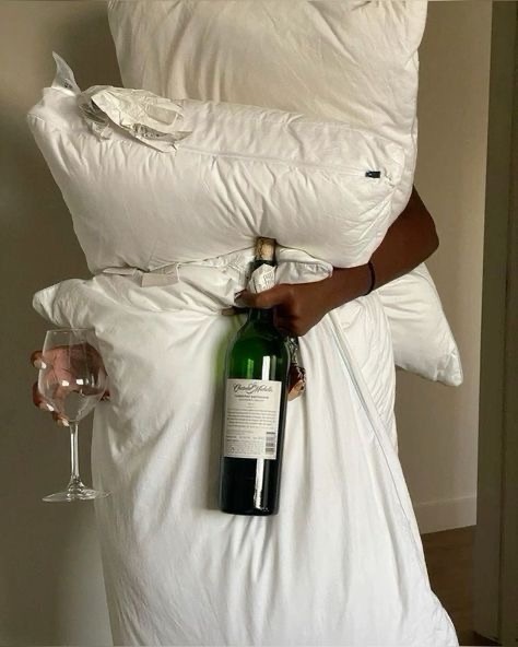 ENERGY SAVING MODE holding pillows and wine