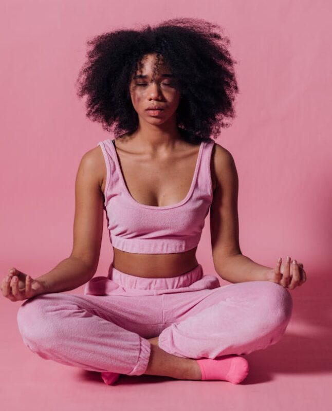 woman in pink crop top and jogging pants practicing yoga - Add More Wellness to Your Busy Schedule