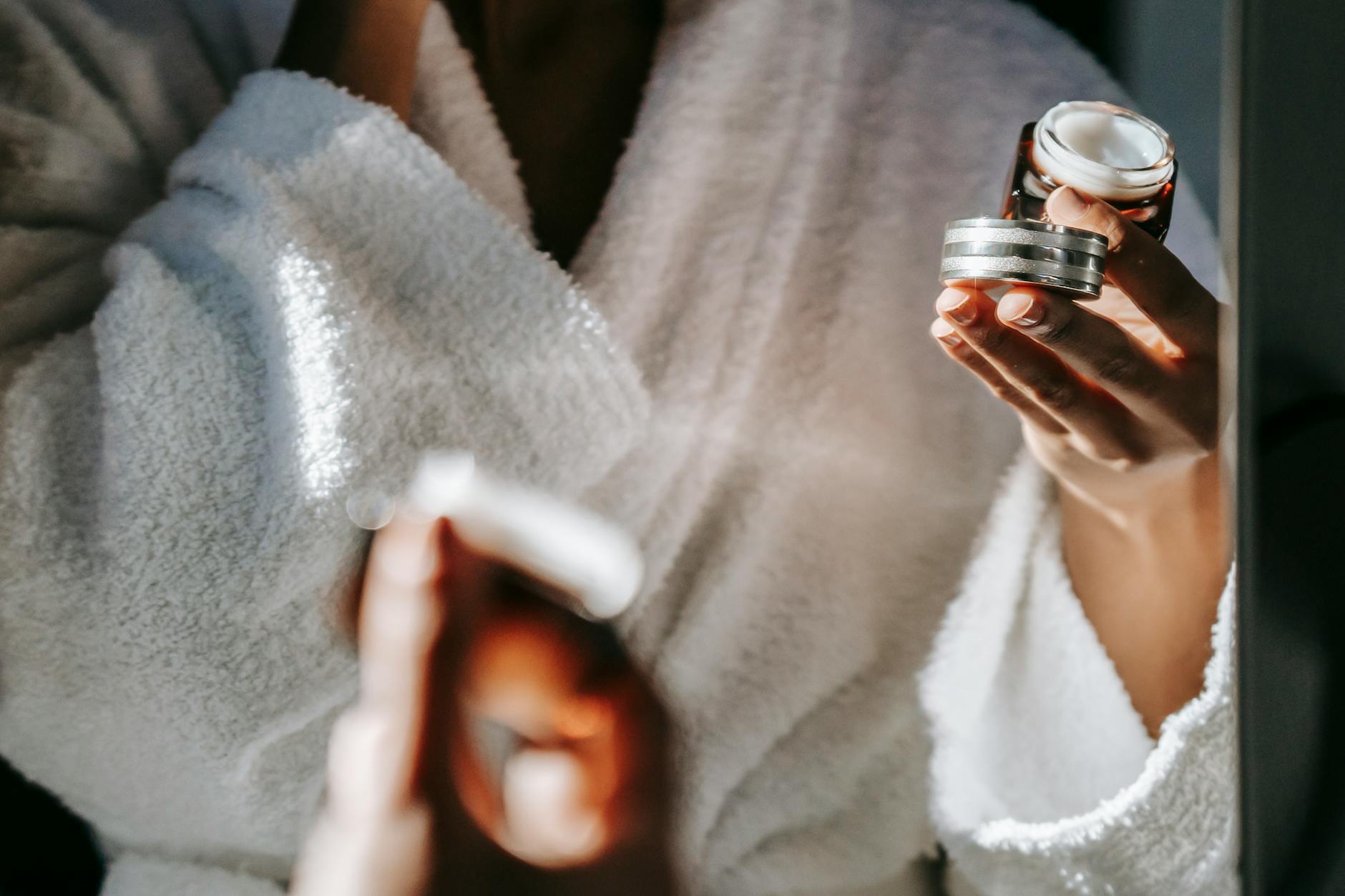 crop ethnic woman with jar of cream against mirror - Luxury Skincare Dupes