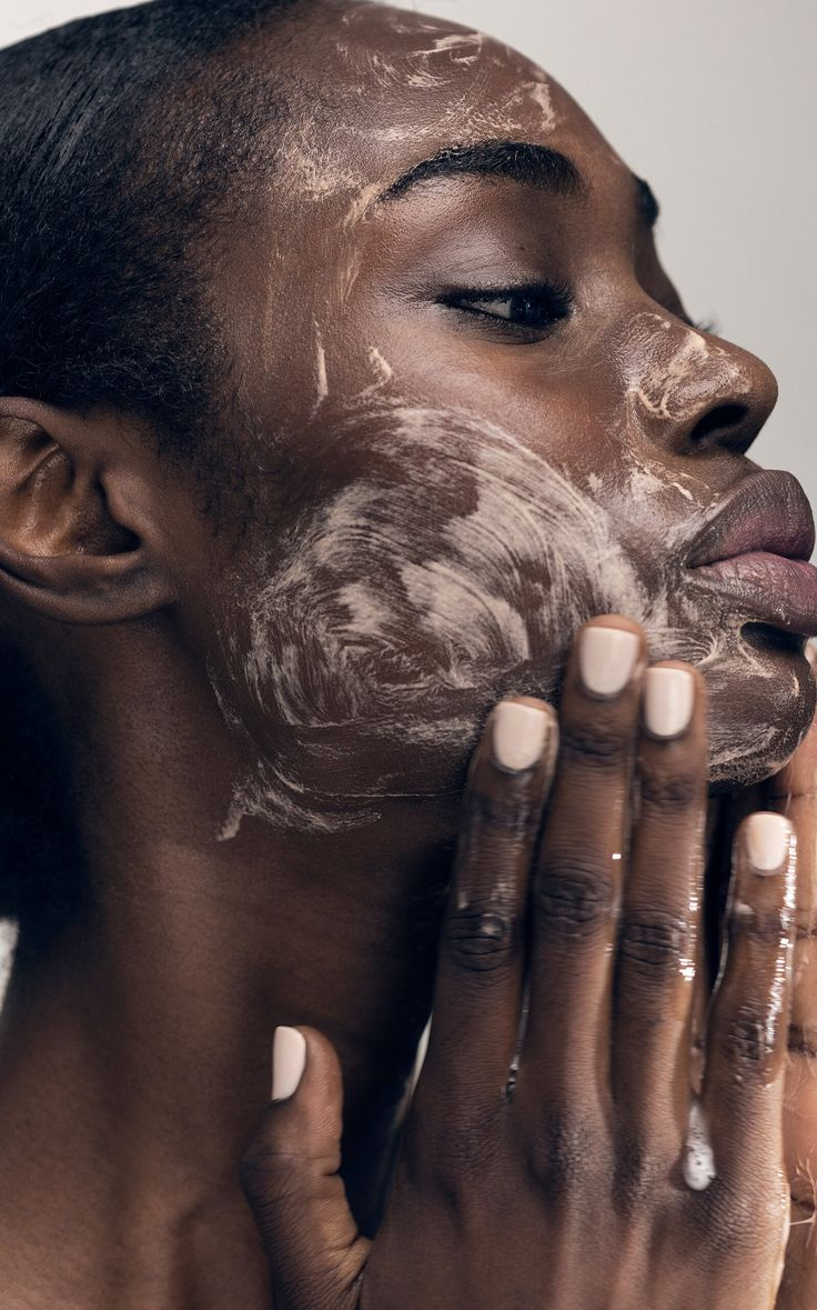 brown skin girl face cleansing to prep dry skin for foundation