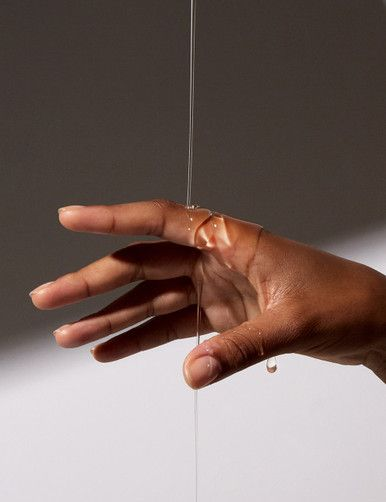 hand with hydrating primer pouring over it