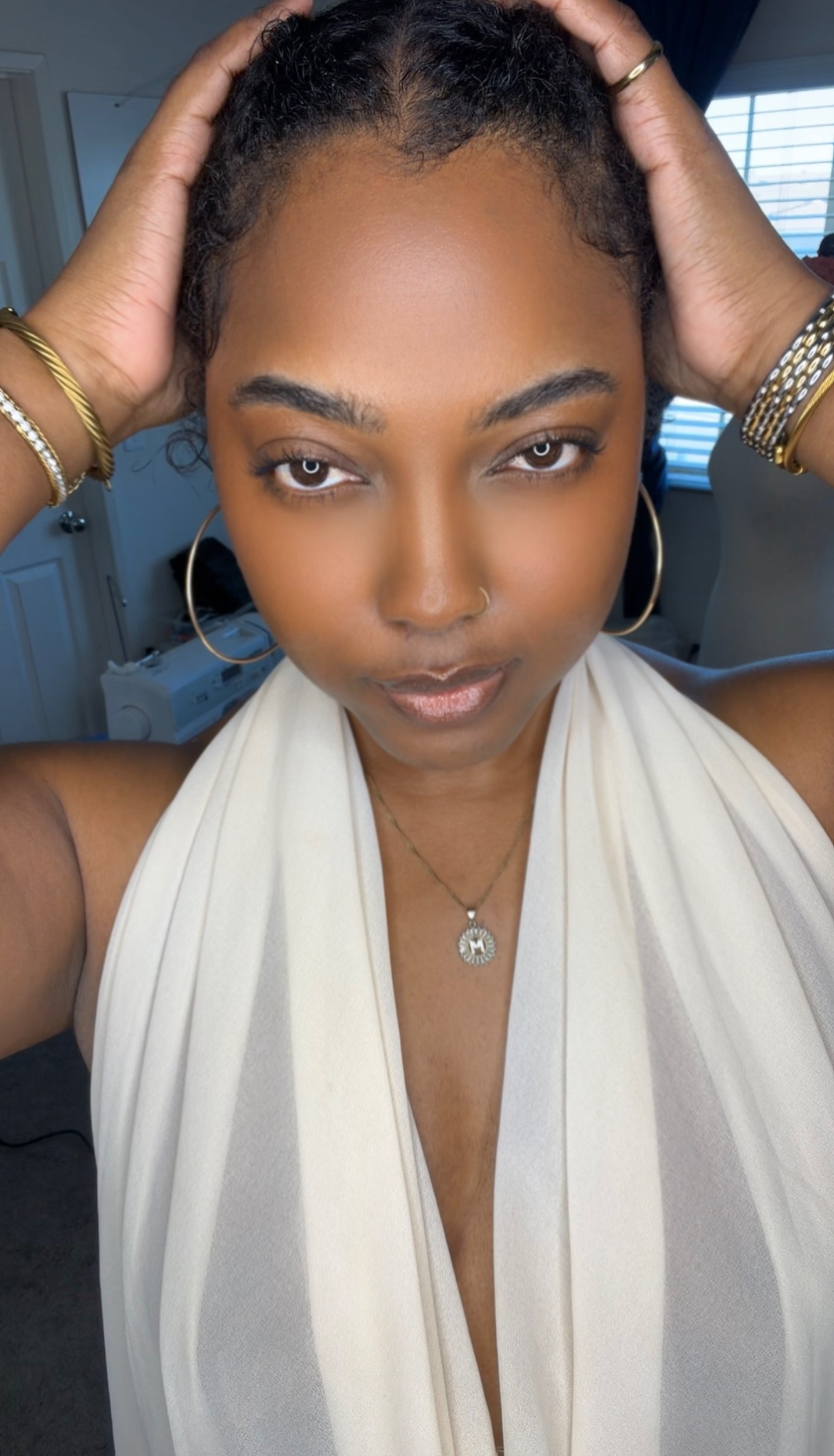Morgan Ashley in a cream halter top and gold jewelry, natural skin, direct gaze &mdash; skin longevity routine at 40